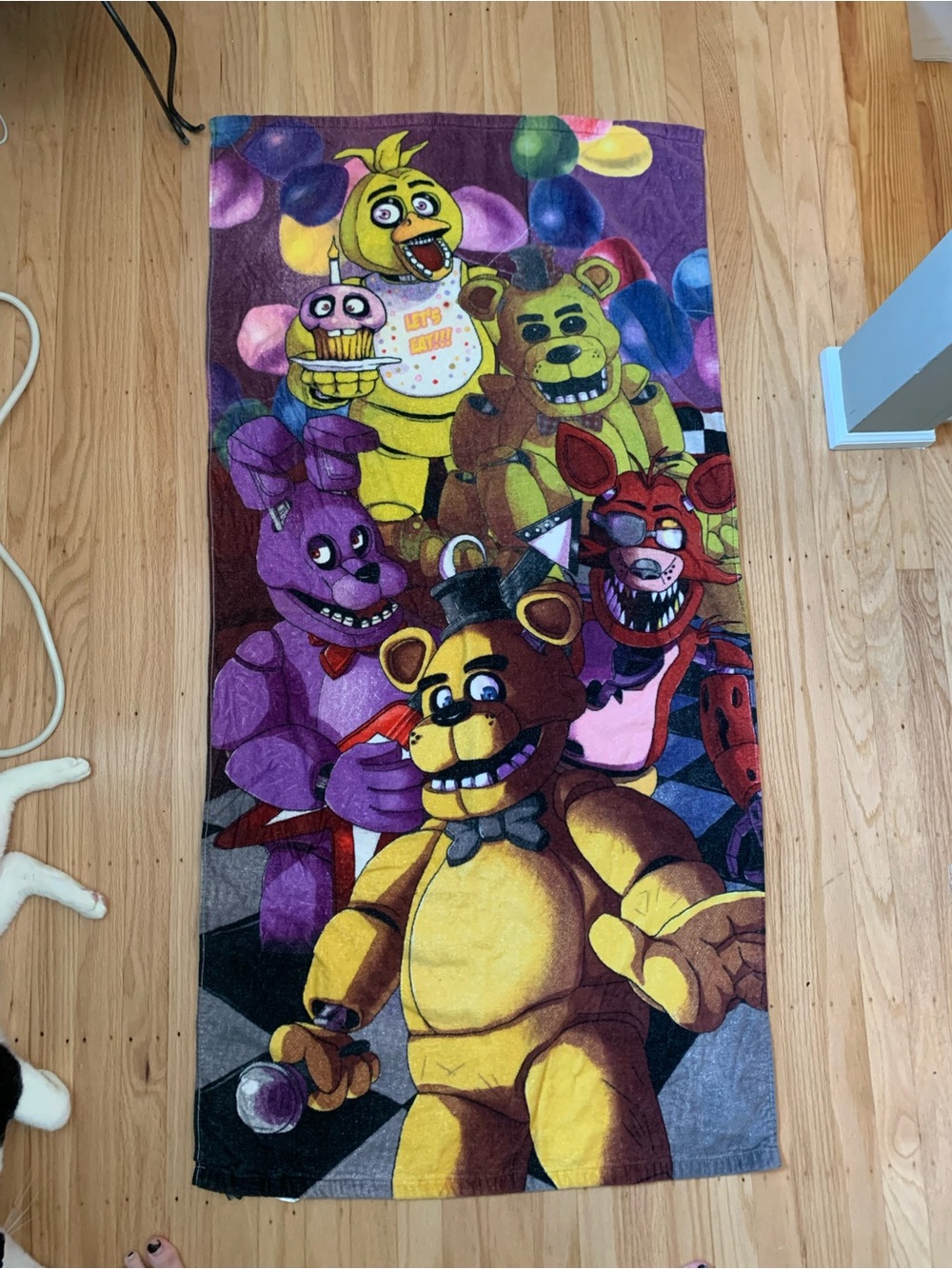 Five Nights at Freddy's beach towel with graphic of animatronic characters